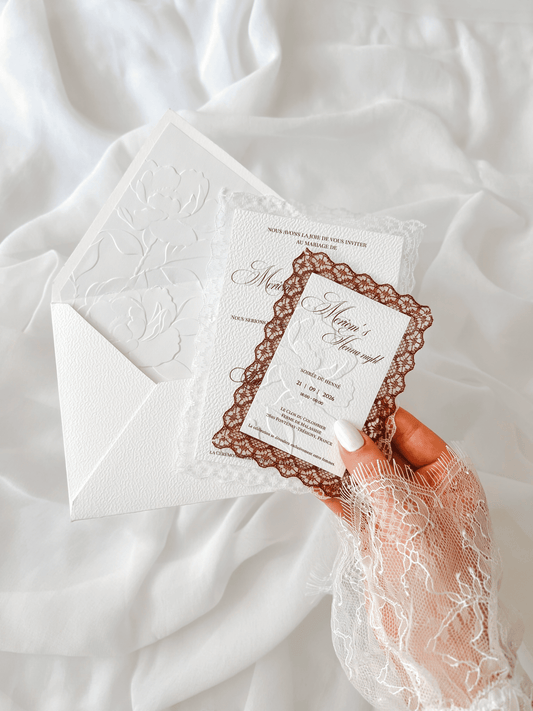 Faire-part de mariage personnalisé Collection LUCIA avec enveloppe blanche, liner intérieur embossé de fleurs, invitation à contour dentelle et carte RSVP assortie en option.