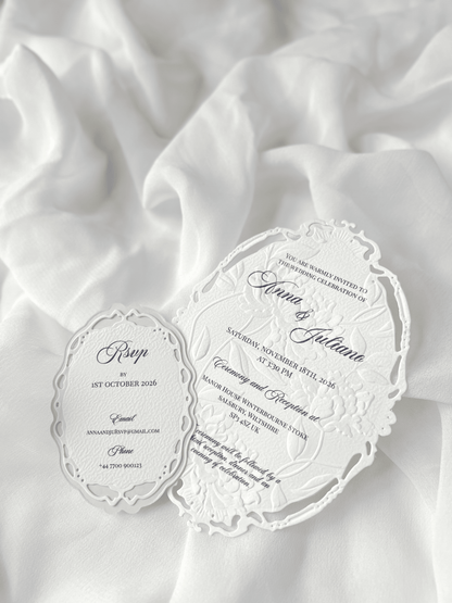 Faire-part de mariage personnalisé Collection WINDSOR avec enveloppe grège embossée, invitation ovale ajourée, ruban en organza, perle décorative et carte RSVP avec monogramme.